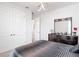 Bright bedroom featuring modern lighting, a comfortable bed with elegant bedding, and a spacious closet at 684 San Augusto Dr, Poinciana, FL 34759