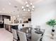 Dining area showcases a modern chandelier and connects to a bright, open kitchen, perfect for entertaining at 684 San Augusto Dr, Poinciana, FL 34759