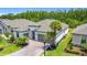 A charming single-Gathering home with a paver driveway, tropical landscaping, and an attached two-car garage at 684 San Augusto Dr, Poinciana, FL 34759