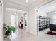 Bright foyer boasts modern lighting, neutral paint, and elegant tile flooring that flows into the open-concept living spaces at 684 San Augusto Dr, Poinciana, FL 34759