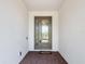 Inviting entryway featuring a decorative glass front door, brick flooring, and white stucco walls at 684 San Augusto Dr, Poinciana, FL 34759