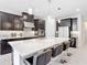 Bright and modern kitchen with dark cabinetry, stainless steel appliances, and a large center island at 684 San Augusto Dr, Poinciana, FL 34759