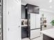 Modern kitchen features stainless steel appliances, sleek black cabinetry, and a bright white refrigerator at 684 San Augusto Dr, Poinciana, FL 34759