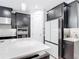 Modern kitchen showcases dark cabinetry, stainless steel appliances, and a bright white refrigerator at 684 San Augusto Dr, Poinciana, FL 34759