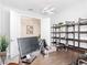 Bright home office features a dark wood desk, shelving, and modern lighting at 684 San Augusto Dr, Poinciana, FL 34759
