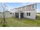 Well-maintained backyard with a screened porch, lush grass, and a privacy fence at 725 Lake Dell Rd, Dundee, FL 33838