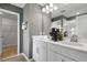 Modern bathroom with double vanity, white cabinets, and elegant fixtures at 725 Lake Dell Rd, Dundee, FL 33838