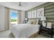 Inviting bedroom showcasing natural light, comfortable bedding, and tasteful wall art at 725 Lake Dell Rd, Dundee, FL 33838