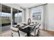 Dining area features sliding glass doors to the backyard, table setting, and lots of natural light at 725 Lake Dell Rd, Dundee, FL 33838
