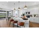Modern kitchen features a large center island, white cabinets, stainless steel appliances, and pendant lighting at 725 Lake Dell Rd, Dundee, FL 33838