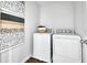 Functional laundry room equipped with modern washer and dryer units at 725 Lake Dell Rd, Dundee, FL 33838