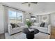 Bright and spacious living room featuring comfortable seating, large windows, and a modern aesthetic at 725 Lake Dell Rd, Dundee, FL 33838