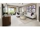 Bright living room with modern furniture, neutral tones, and a sliding glass door at 730 Lake Dell Rd, Dundee, FL 33838