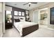 Serene bedroom with soft lighting, a ceiling fan, and a stylish sliding barn door at 730 Lake Dell Rd, Dundee, FL 33838