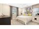Cozy bedroom with a ceiling fan, stylish decor, and lots of natural light at 733 Lake Dell Rd, Dundee, FL 33838