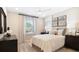Bright bedroom featuring a ceiling fan, large window, and neutral decor at 733 Lake Dell Rd, Dundee, FL 33838