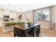 Open concept kitchen and dining area with lots of natural light from large windows at 733 Lake Dell Rd, Dundee, FL 33838