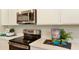 Updated kitchen features stainless steel appliances, sleek countertops, and ample storage space at 733 Lake Dell Rd, Dundee, FL 33838