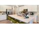 Bright kitchen with white cabinets, stainless steel appliances, and a center island with seating at 733 Lake Dell Rd, Dundee, FL 33838