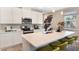 Modern kitchen boasting white cabinetry, stainless steel appliances, and an island with bar seating at 733 Lake Dell Rd, Dundee, FL 33838