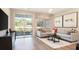 Cozy living room with modern decor, a comfortable sofa, and sliding glass door to the outside at 733 Lake Dell Rd, Dundee, FL 33838