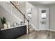 Bright foyer featuring wood-look tile flooring, a staircase, and a stylish console table with decor at 737 Lake Dell Rd, Dundee, FL 33838