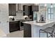 Well-appointed kitchen with dark cabinets, stainless steel appliances, a breakfast bar, and stylish pendant lighting at 737 Lake Dell Rd, Dundee, FL 33838