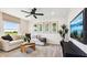 Bright living room featuring a comfortable white couch and modern décor under a ceiling fan at 737 Lake Dell Rd, Dundee, FL 33838