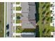 Aerial view of the townhome featuring a gray roof, green lawns, and adjacent street at 740 Madison Dr, Davenport, FL 33837