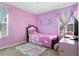 Whimsical bedroom with pink walls, unicorn decor, plush rug, and lots of natural light at 740 Madison Dr, Davenport, FL 33837