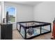 Bedroom with a small playpen, a dark dresser, and a window with outside views at 740 Madison Dr, Davenport, FL 33837