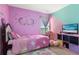 Adorable bedroom featuring pink walls, unicorn themed decorations, and a plush teddy bear at 740 Madison Dr, Davenport, FL 33837