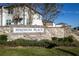 Stone entrance sign for Madison Place with lush landscaping and clear blue sky at 740 Madison Dr, Davenport, FL 33837