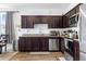 Modern kitchen boasting sleek dark wood cabinetry, stainless steel appliances, and granite countertops at 740 Madison Dr, Davenport, FL 33837
