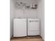 Bright laundry room with modern white washer and dryer units and wire shelving at 740 Madison Dr, Davenport, FL 33837