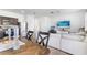 Bright living area featuring a cream sofa, stainless steel appliances, and dark wood cabinets at 740 Madison Dr, Davenport, FL 33837