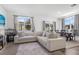 Spacious living area with modern decor seamlessly connects to a dining space and offers plenty of natural light at 740 Madison Dr, Davenport, FL 33837