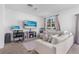 Cozy living room with a fireplace, workspace, plush seating, and a bright window view at 740 Madison Dr, Davenport, FL 33837