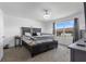 Well-lit main bedroom with a four-poster bed, plush carpet, and outside view through a window at 740 Madison Dr, Davenport, FL 33837