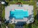 Aerial of a community pool with chaise lounges, palm trees and an enclosed fence at 740 Madison Dr, Davenport, FL 33837