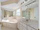 Primary bathroom with a large soaking tub, a walk-in shower, and dual sink vanity at 7431 Sw 129Th Pl, Ocala, FL 34473