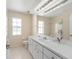 Bright bathroom featuring a vanity with white countertops and a shower with glass doors at 7431 Sw 129Th Pl, Ocala, FL 34473
