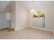 Dining room with vaulted ceiling, modern flooring, a beautiful chandelier, and a large window at 7431 Sw 129Th Pl, Ocala, FL 34473