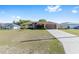 Well-maintained single-Gathering home featuring a spacious driveway and lush green lawn at 7431 Sw 129Th Pl, Ocala, FL 34473