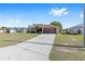 Well-maintained single-Gathering home featuring a spacious driveway and lush green lawn at 7431 Sw 129Th Pl, Ocala, FL 34473