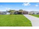 Well-maintained single-Gathering home featuring a spacious driveway and lush green lawn at 7431 Sw 129Th Pl, Ocala, FL 34473