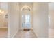 Inviting foyer with tile flooring, decorative glass door, and chandelier lighting at 7431 Sw 129Th Pl, Ocala, FL 34473