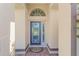 Elegant front entrance with decorative glass door and tiled entryway at 7431 Sw 129Th Pl, Ocala, FL 34473