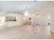 Spacious living room features an open layout, elegant chandelier, and archways, seamlessly connecting to other rooms at 7431 Sw 129Th Pl, Ocala, FL 34473