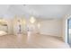 Open-concept living area boasts high ceilings, modern flooring, an elegant chandelier, and abundant natural light at 7431 Sw 129Th Pl, Ocala, FL 34473
